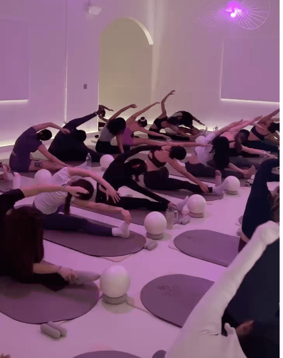 Members in a candlelit pilates class